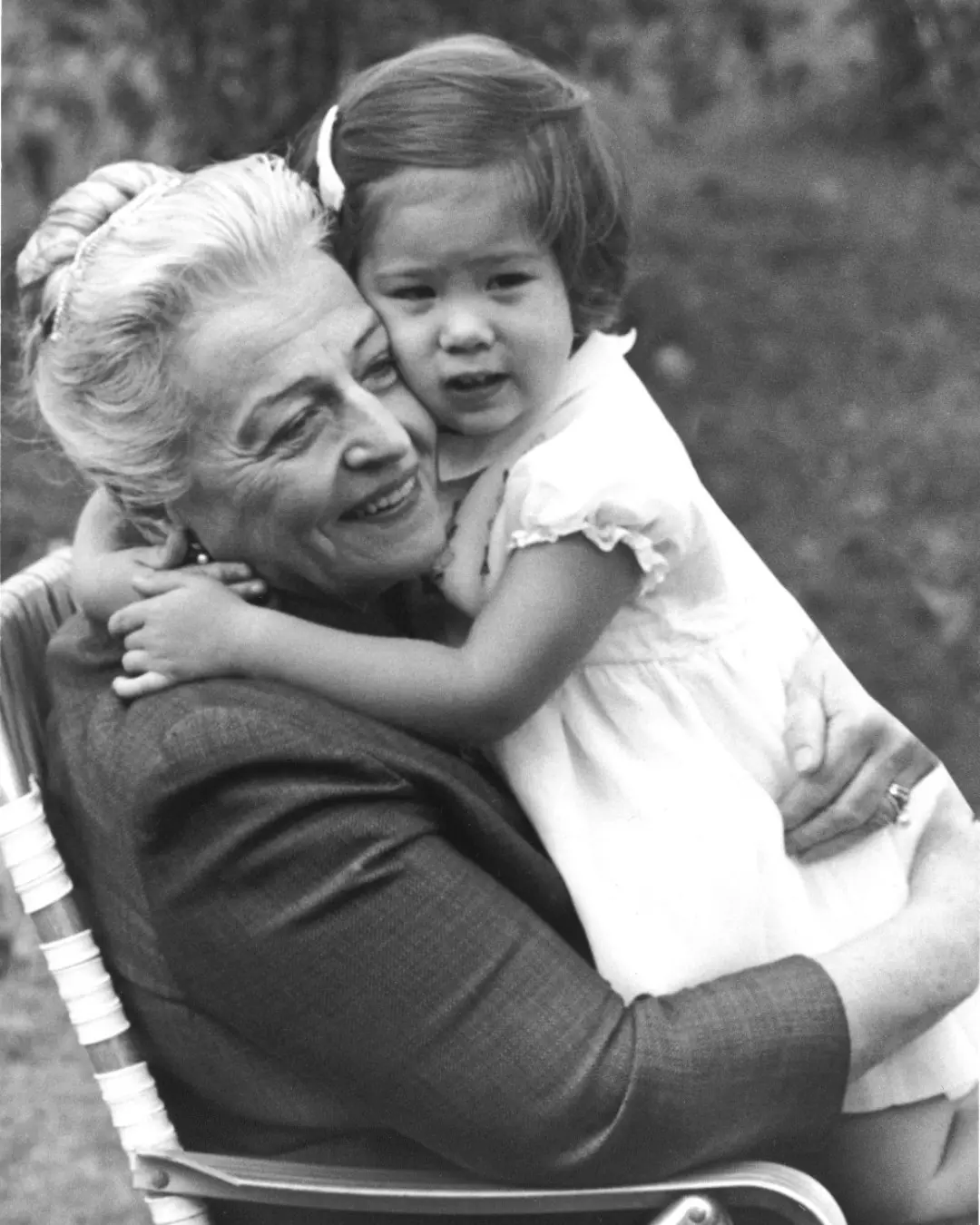 Pearl Buck hugging little girl sitting on her lap