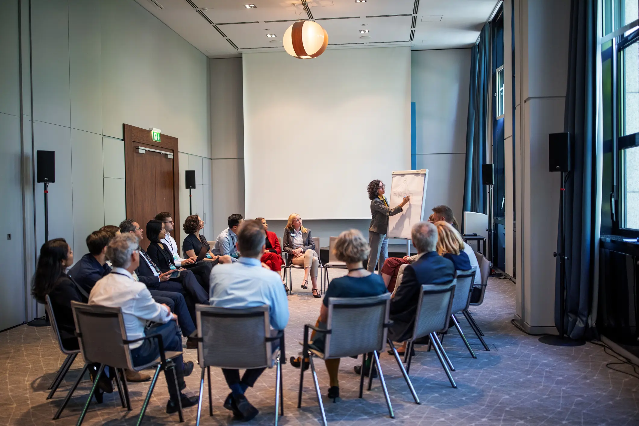 Businesswoman Explaining Strategy Over A Flip Chart