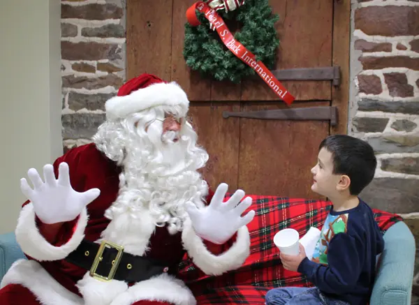 Santa sits with a boy