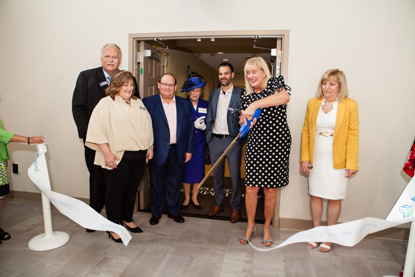 Pearl S. Buck International leadership and board members cut the ribbon at the grand opening of the Janet L. Mintzer Center