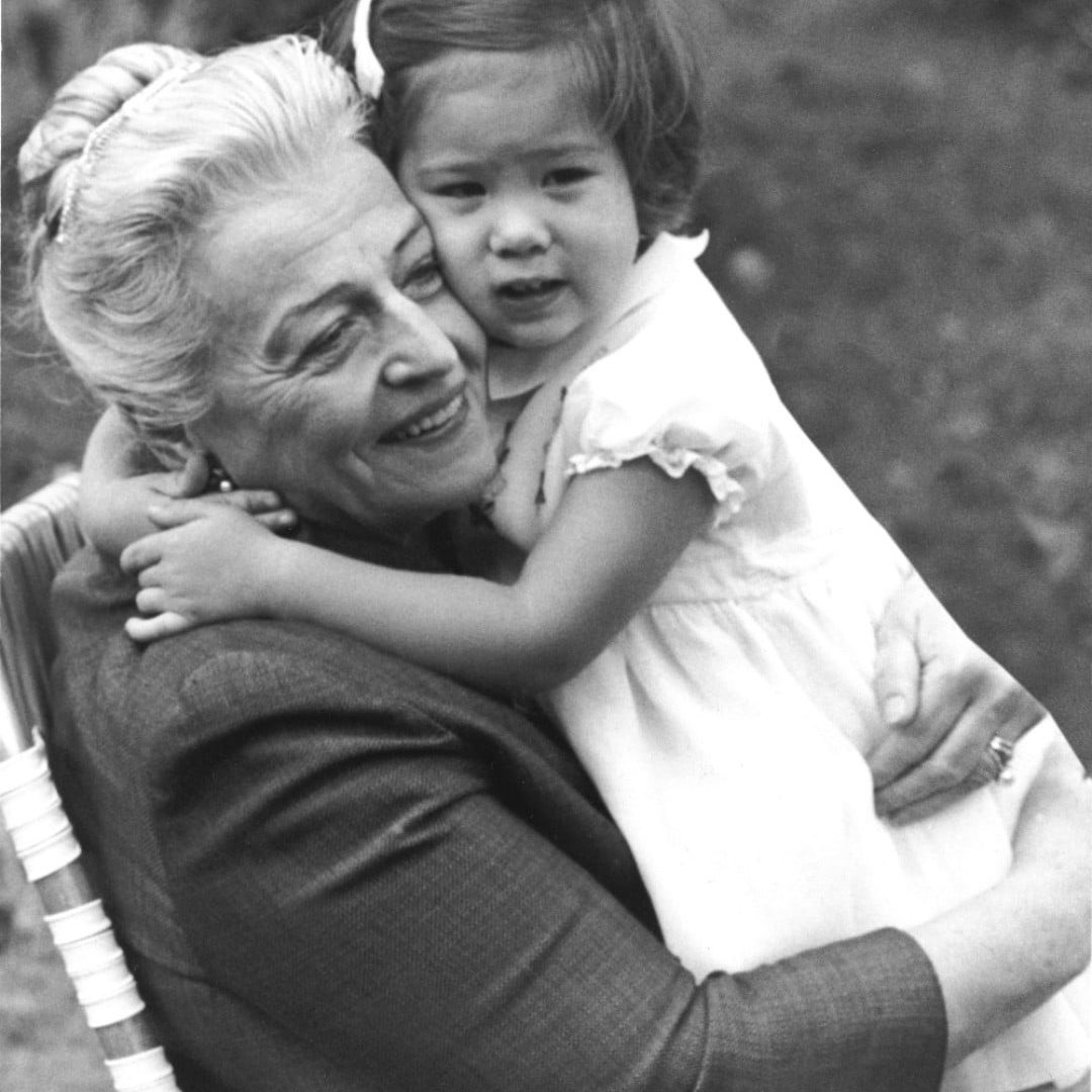Pearl Buck hugging little girl sitting on her lap