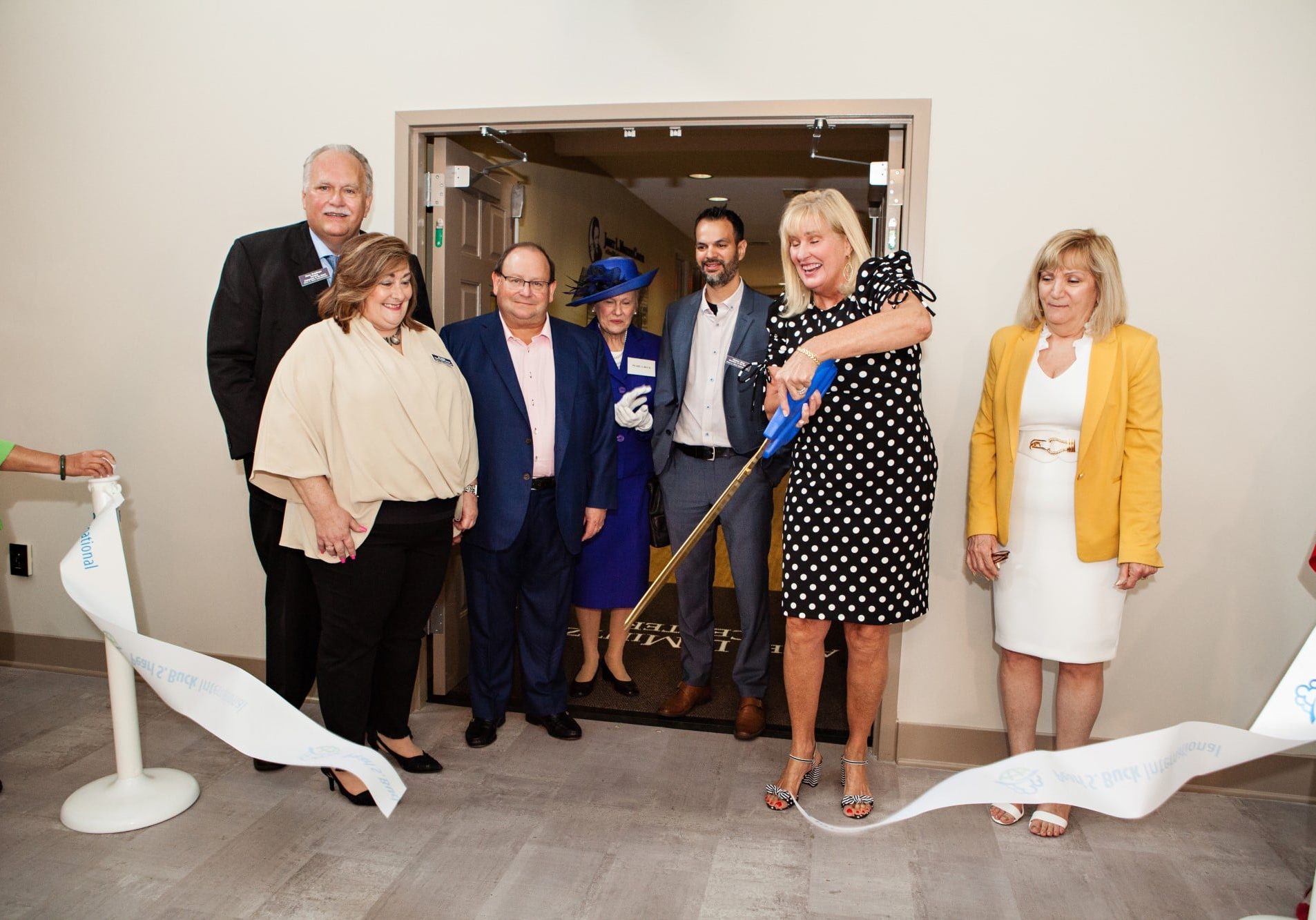 Pearl S. Buck International leadership and board members cut the ribbon at the grand opening of the Janet L. Mintzer Center